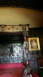 Dark oak panelling and corner of four-poster bed