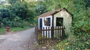 A small cottage with feet poking out of a window