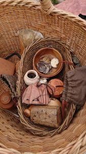 A basket containing pots and other items